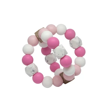 Rosie - rózsaszín és fehér színű labda formájú rágóka Rosie - rózsaszín és fehér színű labda formájú rágóka